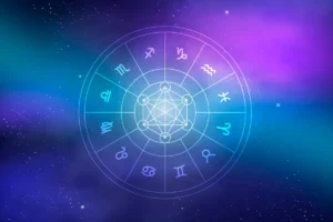 Roda do zodíaco com os doze signos astrológicos em ícones brancos dispostos em um círculo azul e roxo, com o símbolo do Cubo de Metatron no centro, sobre um fundo de nebulosa espacial com estrelas.