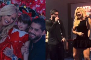 Virginia Fonseca, Zé Felipe e a filha Maria Alice sorriem juntos em um momento familiar. Virginia usa uma roupa casual clara e Zé Felipe segura a filha no colo, que sorri para a câmera em um ambiente iluminado.